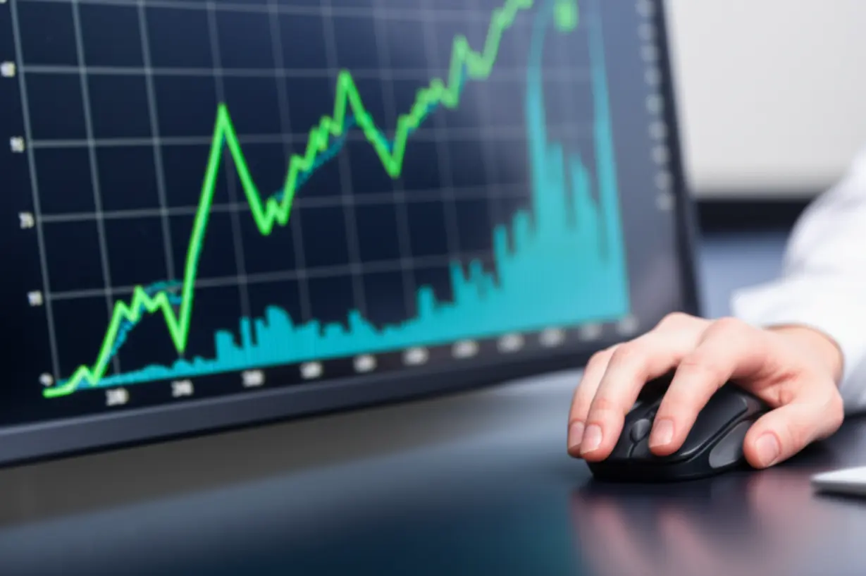 컴퓨터-화면에-보이는-상승-추세의-주식-그래프와-마우스를-잡은-손-클로즈업,-직접-투자의-성장을-나타내는-이미지