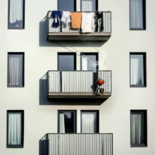 Cute-3D-illustration-of-apartment-balconies-with-grill-smoke-rising-to-laundry-above.