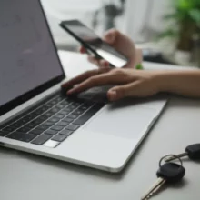 Laptop-and-smartphone-showing-online-payment-interface,-with-car-keys-and-calendar-indicating-tax-deadline.