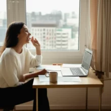 A-young-person-using-a-laptop-in-their-apartment,-applying-for-rent-support.