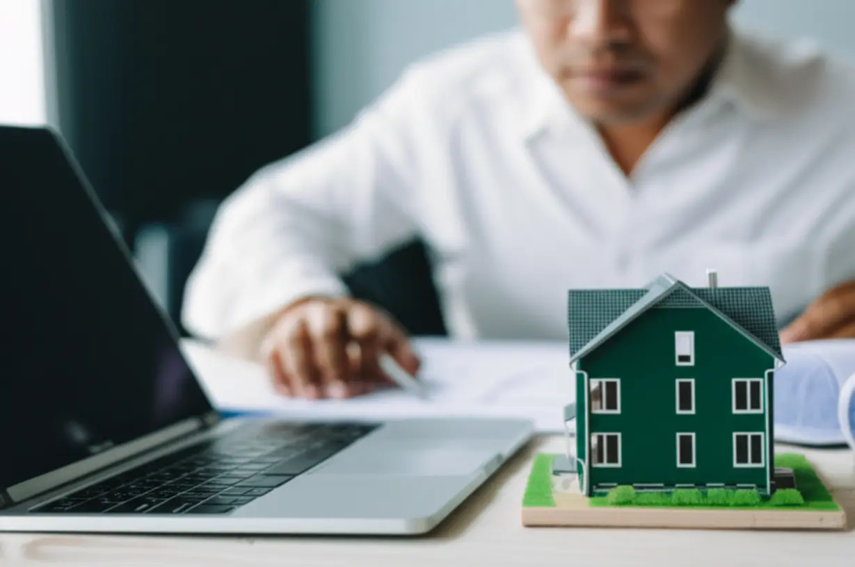 Person-planning-home-purchase-or-upgrade-on-laptop