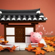 추석-연휴-주식시장-휴장-기간의-불안감을-상징하는-귀여운-한옥과-주식-그래프,-저금통이-함께-있는-모습.-현명한-주식-투자-전략을-고민하는-투자자들을-위한-이미지입니다.